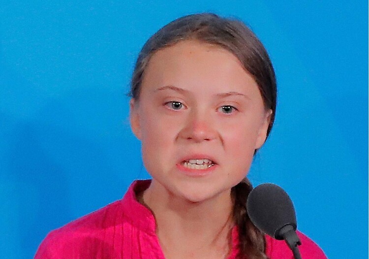 Greta Thunberg at the UN in 2019, mid-speech, glaring.
